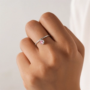 Detail of S925 silver ring featuring braided texture and a pink zircon pendant