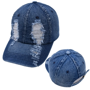 Close-up of distressed denim ponytail baseball cap showing frayed edges and adjustable strap