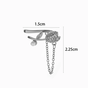 Detail of silver butterfly ear cuff with micro-pave zircons, small pearl and chain tassels