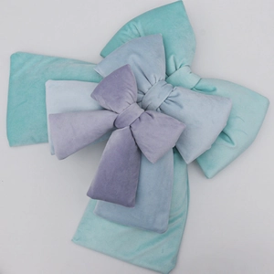 Velvet bow cushions in light blue and green colors for wedding and home decoration