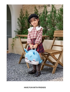 Sky blue EVA cartoon bunny backpack for kids shown on a toddler in an outdoor garden