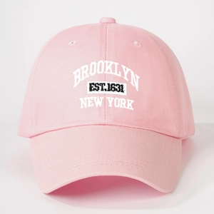 Detailed close-up of pink baseball cap featuring white Brooklyn New York embroidery