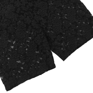 Close-up of intricate black floral lace fabric with delicate cutout patterns on bodysuit
