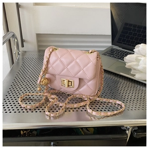 Detailed close-up of pink quilted mini bag with gold-tone metal clasp and chain strap