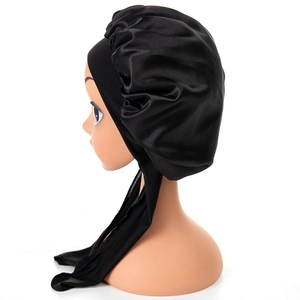 Black satin hair bonnet with long ties for babies, featuring smooth silk-like texture