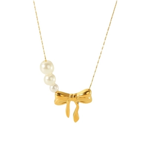 18k gold plated titanium steel necklace with bow pendant and white pearls on white background