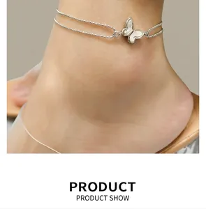 Detail of silver double-layered butterfly anklet with mother-of-pearl charm on ankle