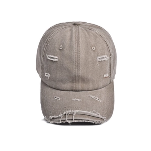 Detailed view of the vintage washed cotton baseball cap with distressed torn edges