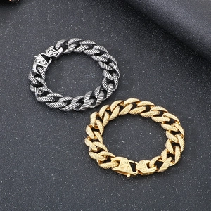 Detail of vintage 18k gold and silver plated Cuban link bracelets with engraved clasps