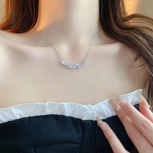 Elegant silver teardrop zircon necklace worn by a model in warm natural light