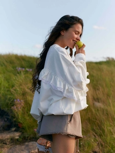 White long-sleeve knit top featuring lace ruffles and a loose casual fit for women