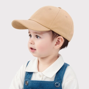 Detail of classic beige cotton kids baseball cap featuring breathable eyelets and twill texture