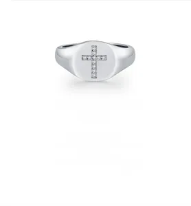 Macro detail of S925 silver signet ring with sparkling moissanite cross design
