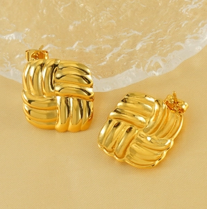 Macro shot of 18k gold plated stainless steel earrings with square textured weave design