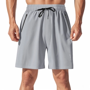 Detail of gray quick-dry sports shorts showing hidden zipper pocket and BUTZ logo drawstring