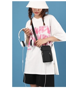 Close-up of black crossbody phone bag with heart-shaped zipper and exterior pocket