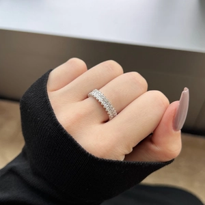 Detail of S925 sterling silver ring with baguette-cut stones worn by a model