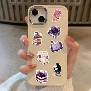 Macro view of Gothic Bookish Witch stickers with black cat and wizard hat on phone case