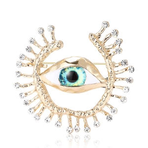 Elegant gold evil eye brooch with blue stone, sparkling rhinestones and radial eyelashes