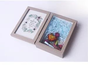 Close-up of wooden shadow box frame with dried flowers and raffia DIY inner decor