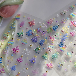 Detailed macro view of 3D Christmas tree nail stickers with glitter and pearl accents
