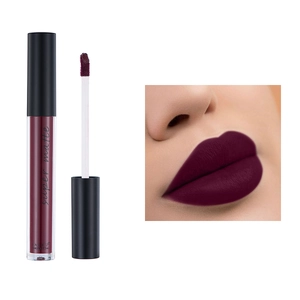Deep burgundy super matte liquid lipstick with applicator and lip swatch on white background