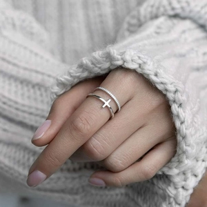 Macro shot of 925 sterling silver double-layer cross ring with inset cubic zirconia stones