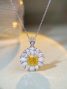 Macro detail of silver necklace with square yellow gemstone and petal zircons