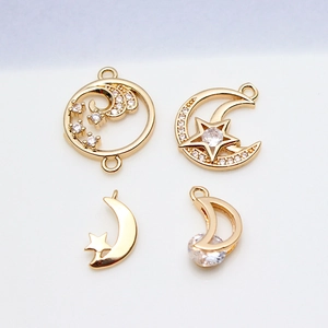Set of four gold star and moon jewelry pendants with sparkling zircon stone accents