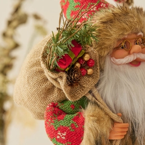 Standing Santa Claus figurine with lantern and gift bag for Christmas home decor