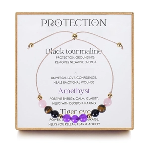 Macro detail of natural crystal protection bracelet with stones in gift box packaging