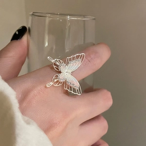 Elegant silver butterfly ring with mother of pearl and zircons on a model's finger