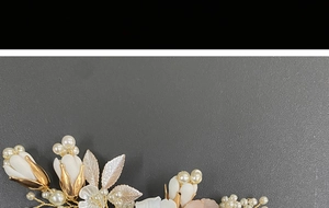 Detail of bridal hair comb with gold leaves, white ceramic flowers and imitation pearls