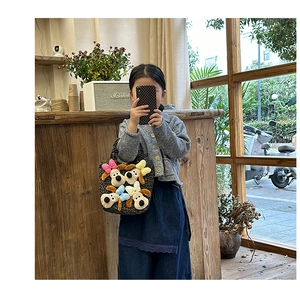 Detail of child handbag with 3D plush puppy heads and trendy leopard print fabric