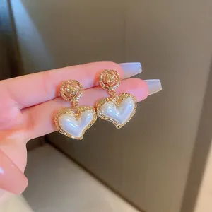 French vintage gold hollow rose and pearl heart earrings for women with elegant style