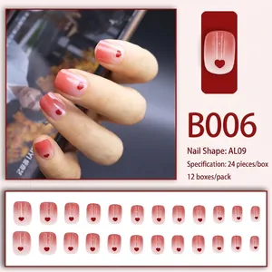 Short press-on nails set featuring red heart patterns and soft blush gradient finish