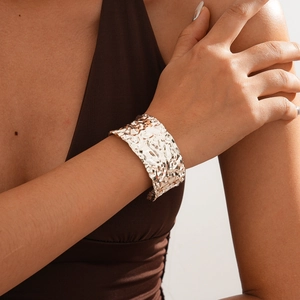 Lava texture wide open bangle in gold finish on female wrist for a vintage look