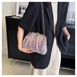 Close-up of iridescent sequin clutch with crystal trim and gold chain on a model