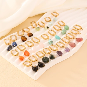 Elegant gold huggie hoop earrings featuring natural raw gemstones in various colors