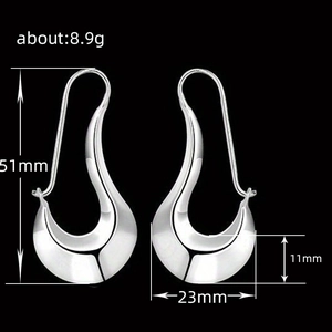 Minimalist silver irregular waterdrop earrings with dimensions 51mm by 23mm shown on black