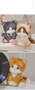 Detail of plush cat doll with soft faux fur, large eyes and cute pink paw pads
