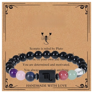 Macro view of Scorpio beaded bracelet with natural obsidian on themed display card