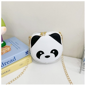 Detail of panda crossbody bag featuring dual gold zippers and metallic chain strap