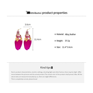 Detail view of Bohemian long rose red feather earrings with vintage alloy leaf accents