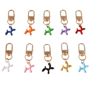 Set of ten colorful balloon dog keychains with gold lobster clasps in matrix layout