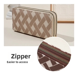 Close-up of the smooth double metal zipper detail on this striped long wallet