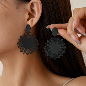 Matte black sunflower geometric earrings on model for a vintage bohemian look
