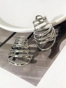 Macro shot of silver multi-layer spiral hoop earrings with polished metallic finish