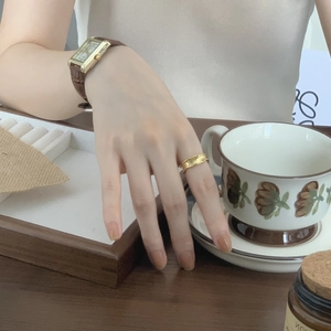 Detail of irregular S925 silver ring in gold finish paired with a vintage watch