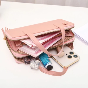 Pink double zipper crossbody phone bag with tassel and spacious internal storage